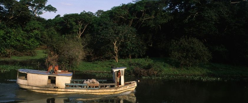 A river boat carrying locals, travel up the Amazon. 