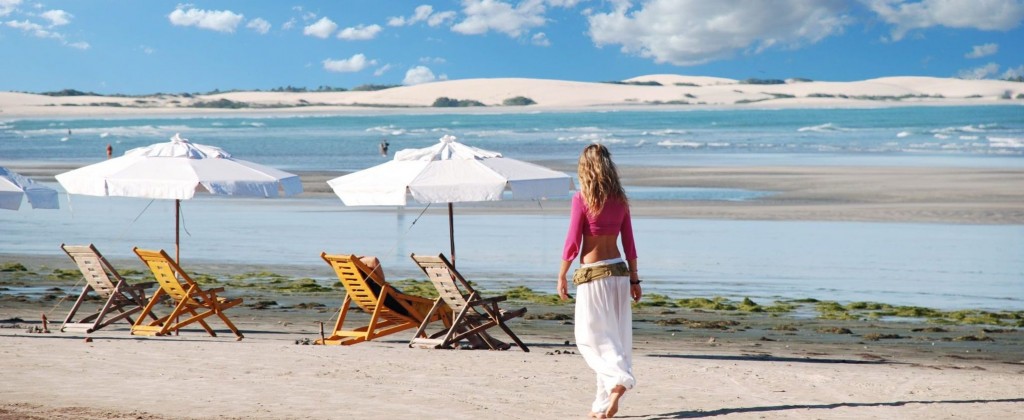 A woman take a leisurely stroll in Jericoacoara, a small beach town in the Northeast of Brazil. 