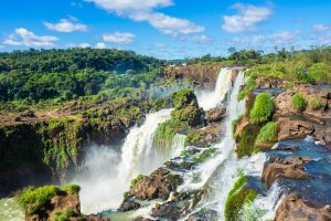 A long - distance shot of the rocky waterfalls at Iguazu. 