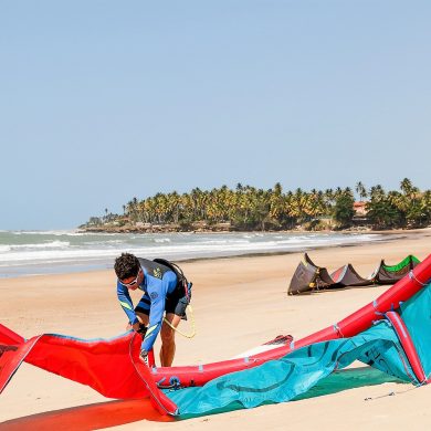 Man prepares his kite to go kitesurfing.