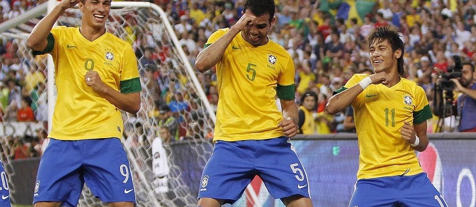 Brazilian footballers dance.