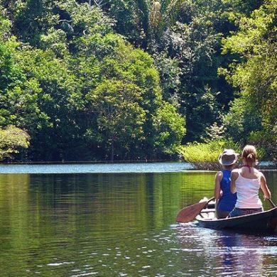 A couple row on an Amazonian River in Brazil.
