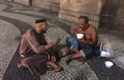 Catholic monk from a religious order, eating with poor in Brazil.